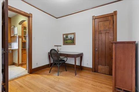 a workspace room with furniture and wooden floor