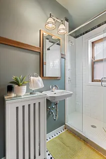 a bathroom with a sink a mirror and a bathtub