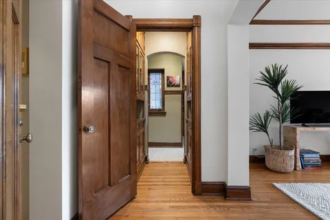 a view of a hallway with furniture and a potted plant
