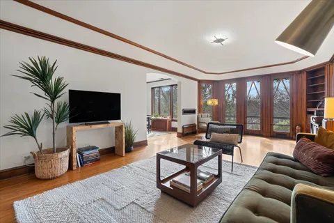 a living room with furniture a flat screen tv and a large window