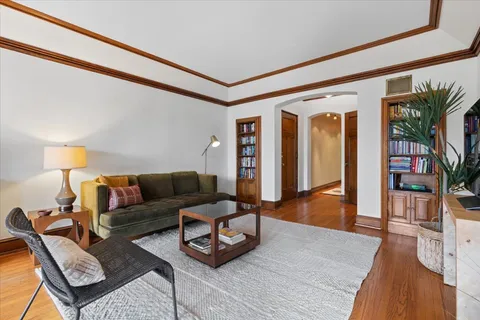 a living room with furniture and wooden floor