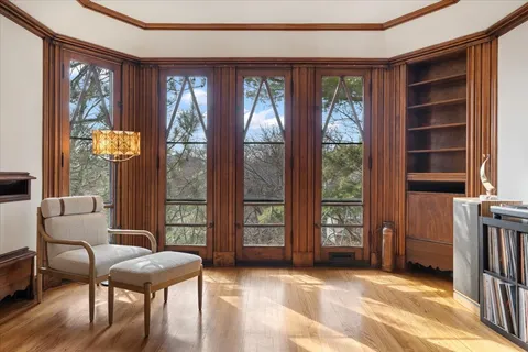 a view of an empty room with furniture and windows