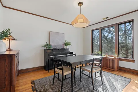 a view of a dining room with furniture window and wooden floor