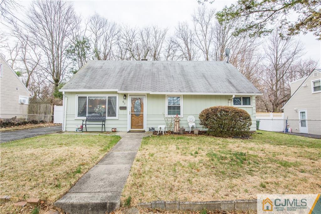 a view of a house with a yard and sitting area