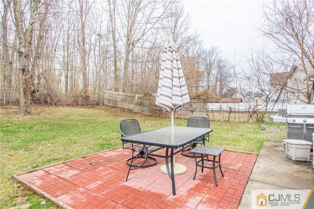 53 Ashley Road Edison, NJ 08817 - Photo 12 of 13 a backyard of a house with table and chairs