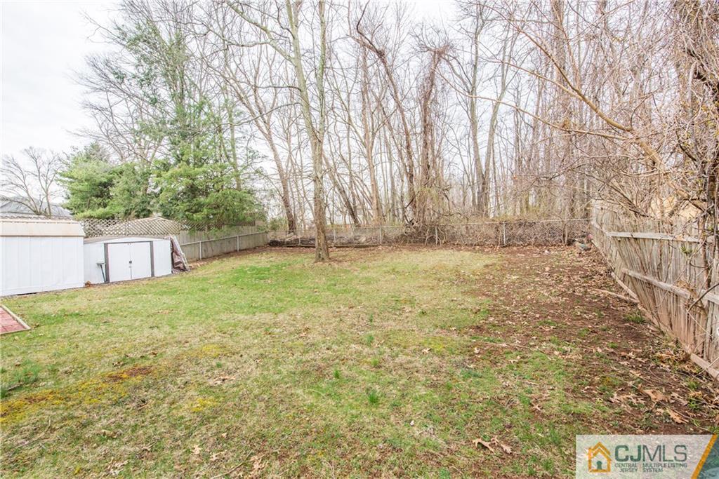 53 Ashley Road Edison, NJ 08817 - Photo 13 of 13 a view of a yard with a trees