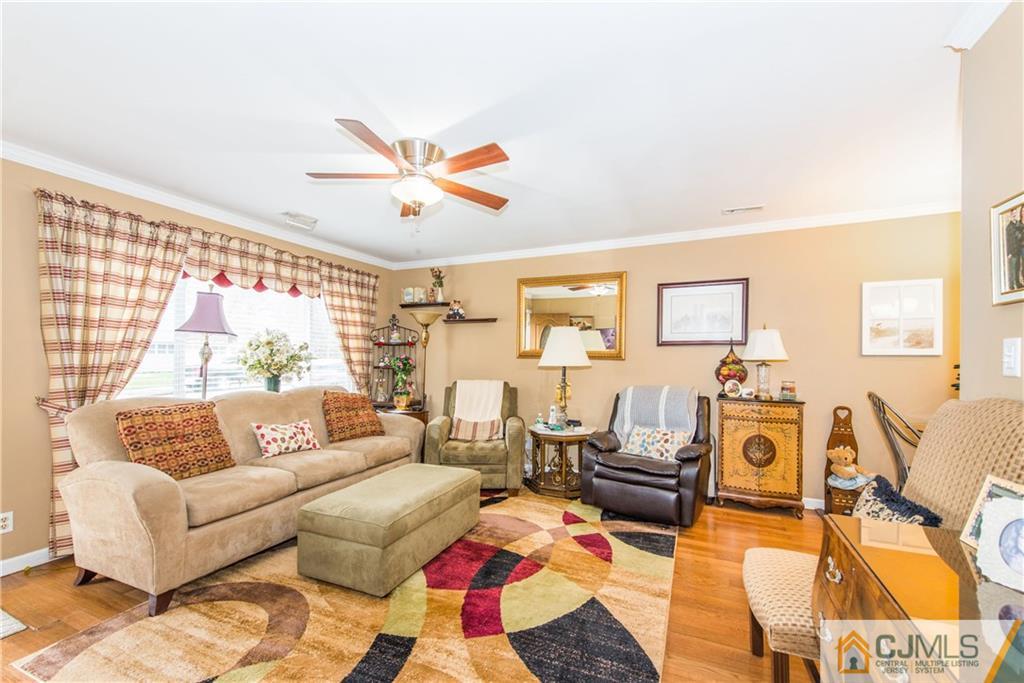 53 Ashley Road Edison, NJ 08817 - Photo 3 of 13 a living room with furniture a fireplace and a flat screen tv