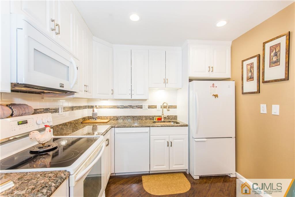 53 Ashley Road Edison, NJ 08817 - Photo 5 of 13 a kitchen with a sink a stove a refrigerator and cabinets