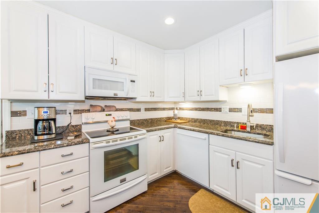 53 Ashley Road Edison, NJ 08817 - Photo 6 of 13 a kitchen with cabinets appliances a sink and a counter space