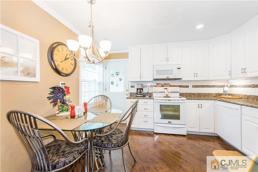 53 Ashley Road Edison, NJ 08817 - Photo 7 of 13 a view of a dining room with furniture a kitchen and wooden floor