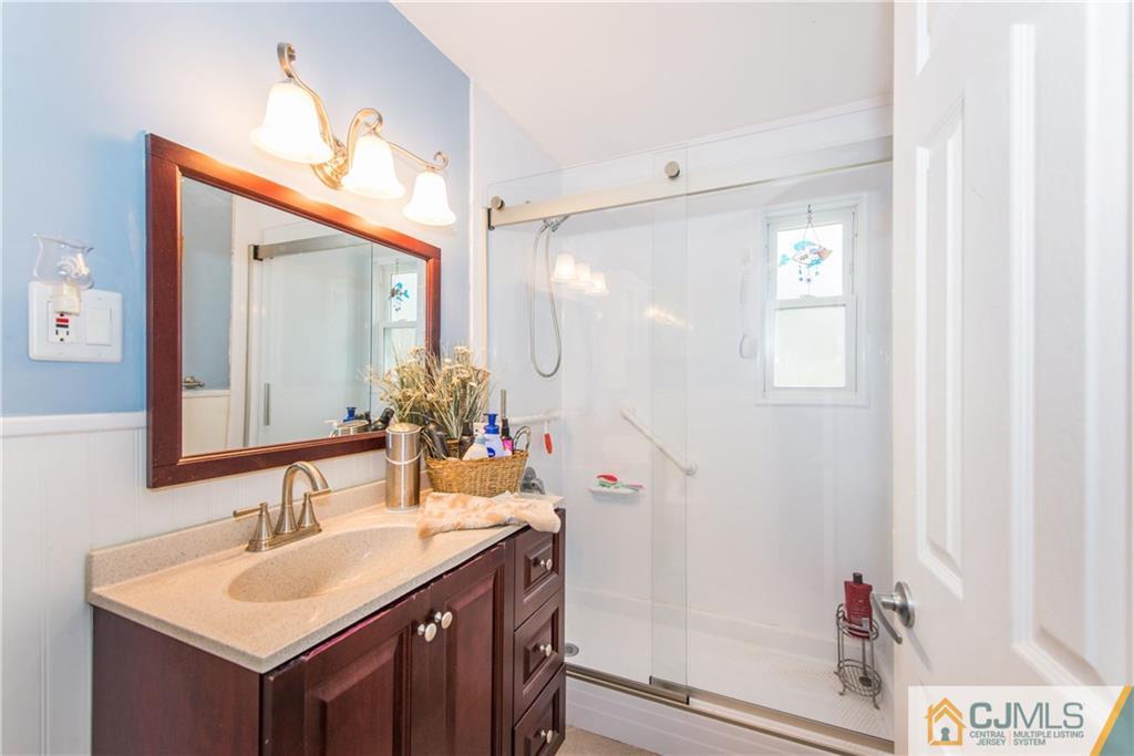 53 Ashley Road Edison, NJ 08817 - Photo 8 of 13 a bathroom with a sink and a mirror