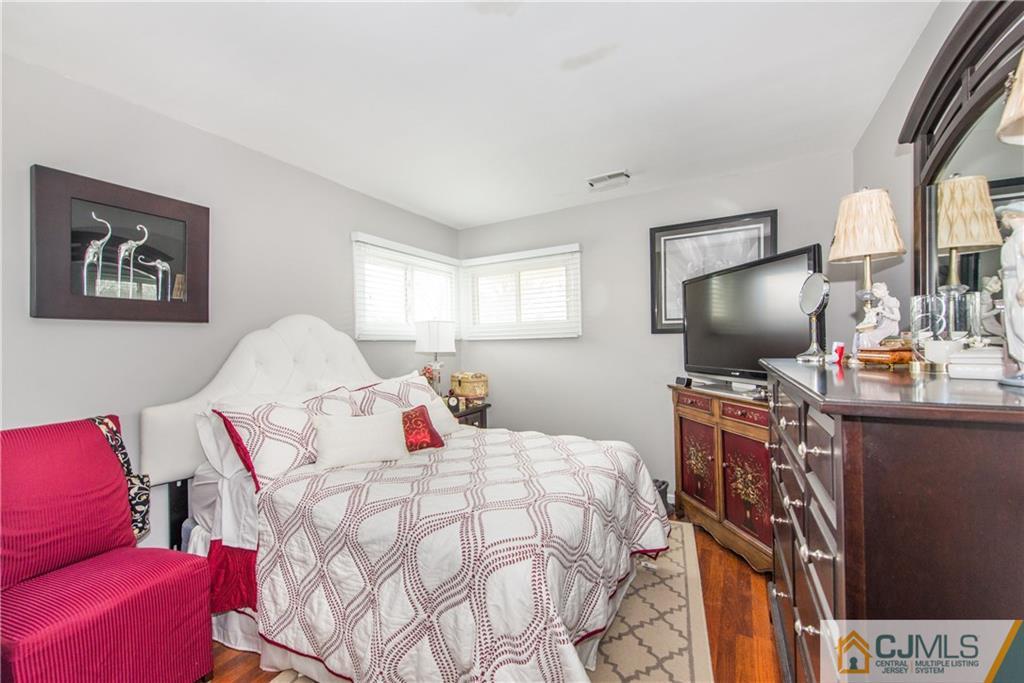53 Ashley Road Edison, NJ 08817 - Photo 9 of 13 a bedroom with a bed and flat screen tv