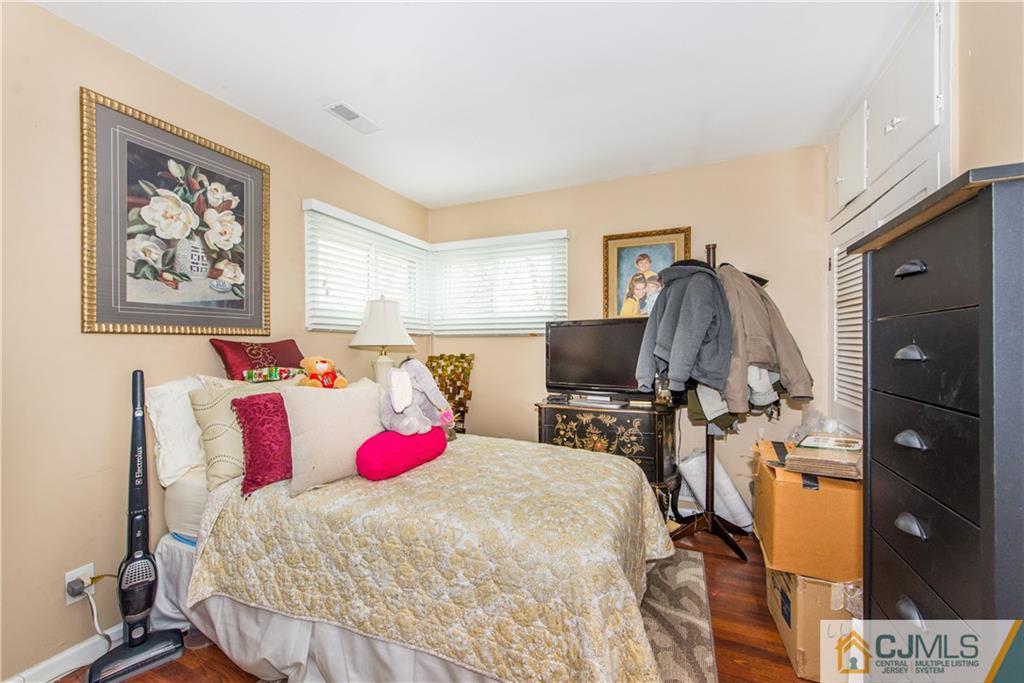 53 Ashley Road Edison, NJ 08817 - Photo 10 of 13 a bedroom with a bed and a flat screen tv