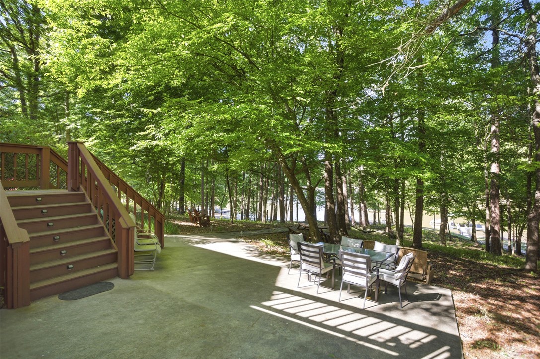 110 Snug Harbor Road Seneca, SC 29678 - Photo 28 of 37 This serene outdoor space offers a private patio with wooded views and direct access to the lake.
