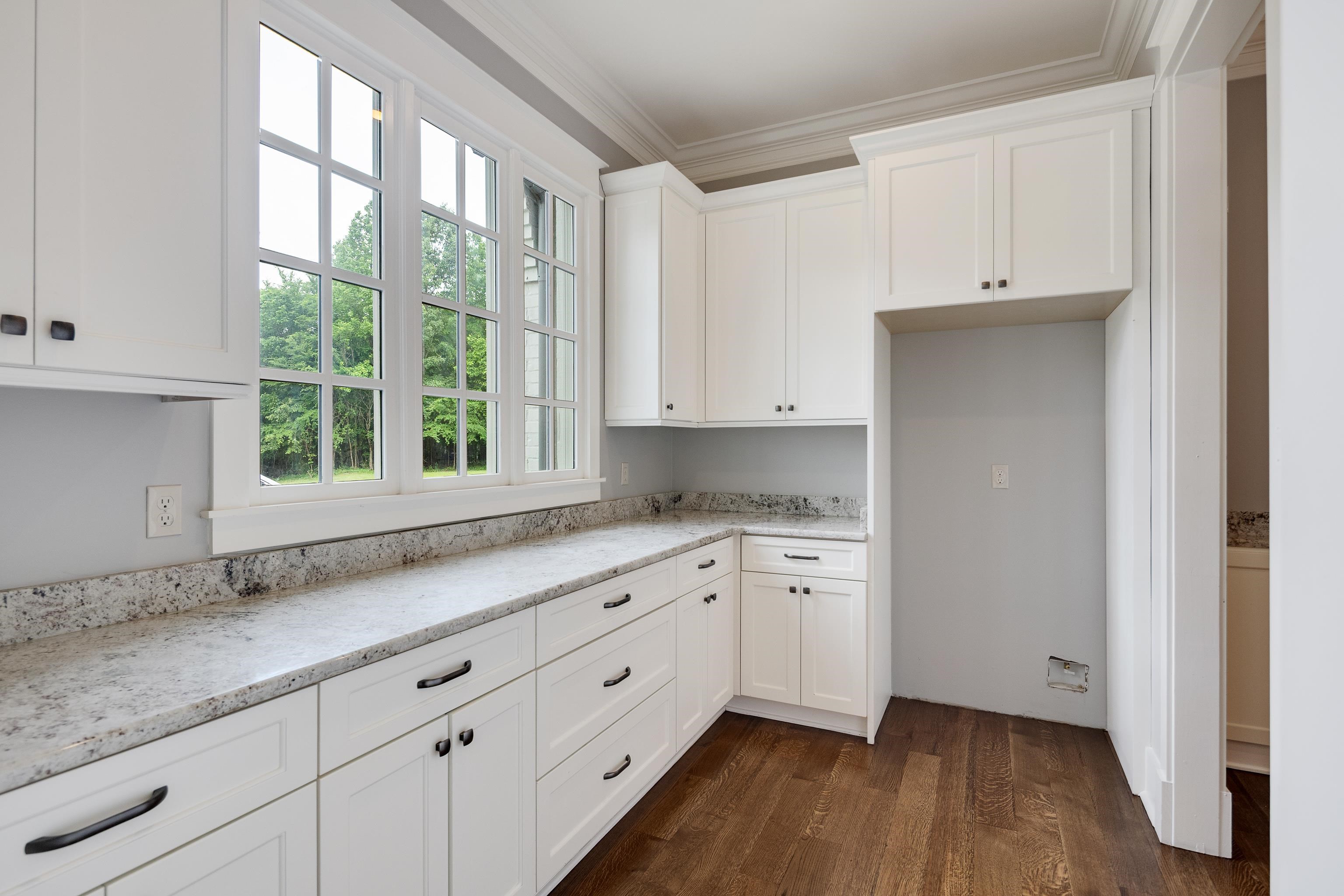 55 East Old State Line Road Piperton, TN 38017 - Photo 15 of 40 Kitchen featuring white shaker cabinetry, speckled countertops, dark wood-finish flooring, and a window with multiple panes