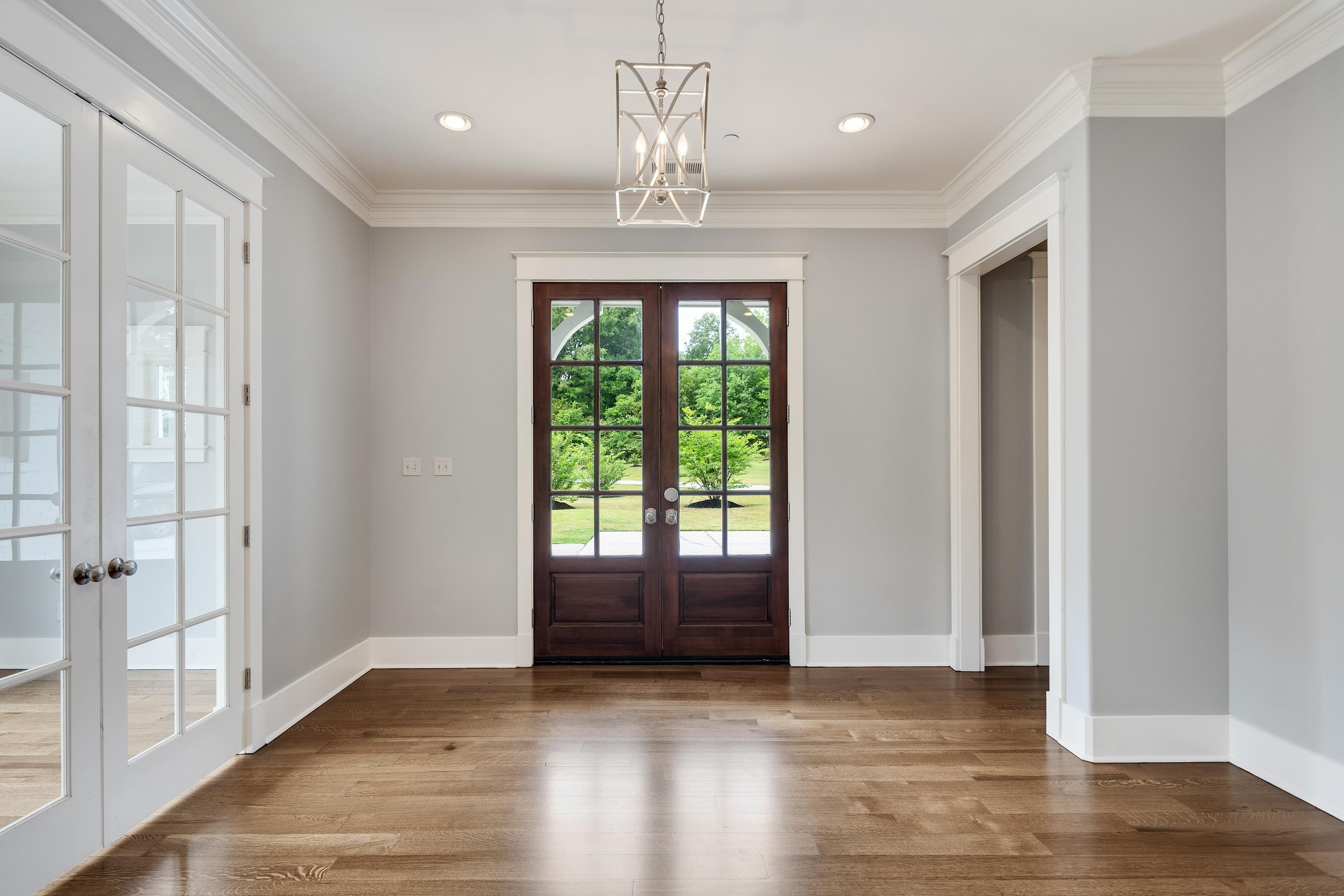 55 East Old State Line Road Piperton, TN 38017 - Photo 18 of 40 Foyer featuring rich wood-finish flooring, dark wood double-entry doors with glass panes, and crisp white trim