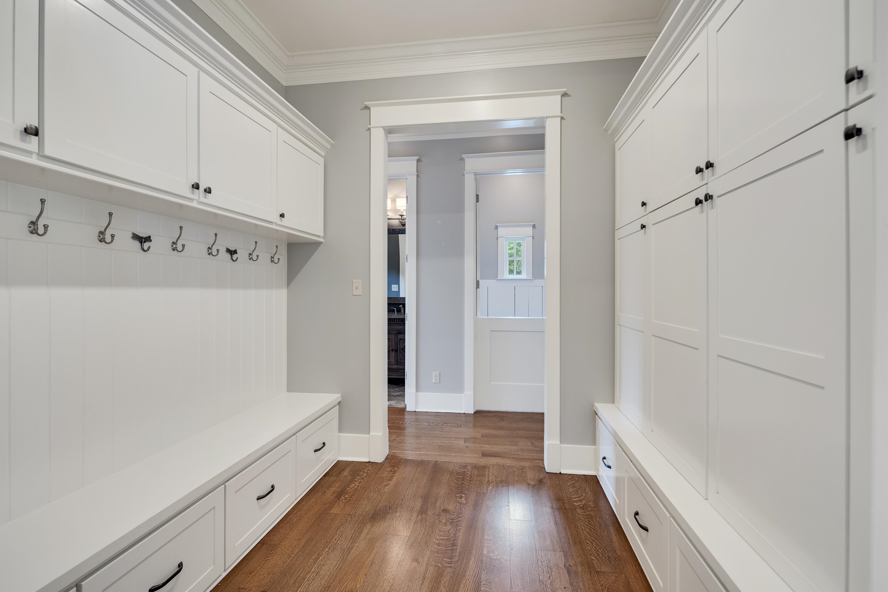 55 East Old State Line Road Piperton, TN 38017 - Photo 20 of 40 Dedicated mudroom area featuring extensive built-in cabinetry, integrated bench seating, and wood-finish flooring