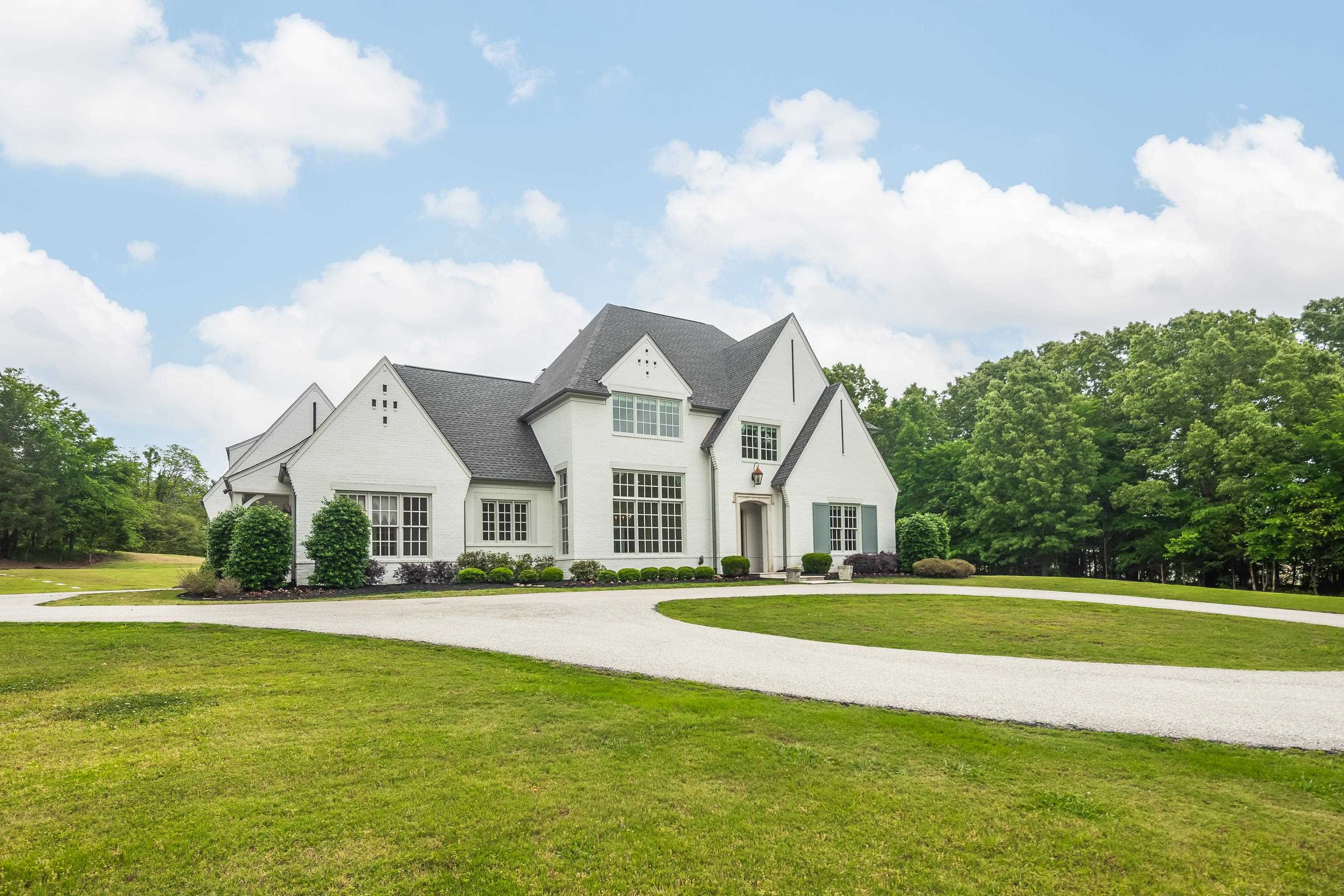 55 East Old State Line Road Piperton, TN 38017 - Photo 2 of 40 White brick exterior with a dark shingle roof, featuring multiple gables and dormers