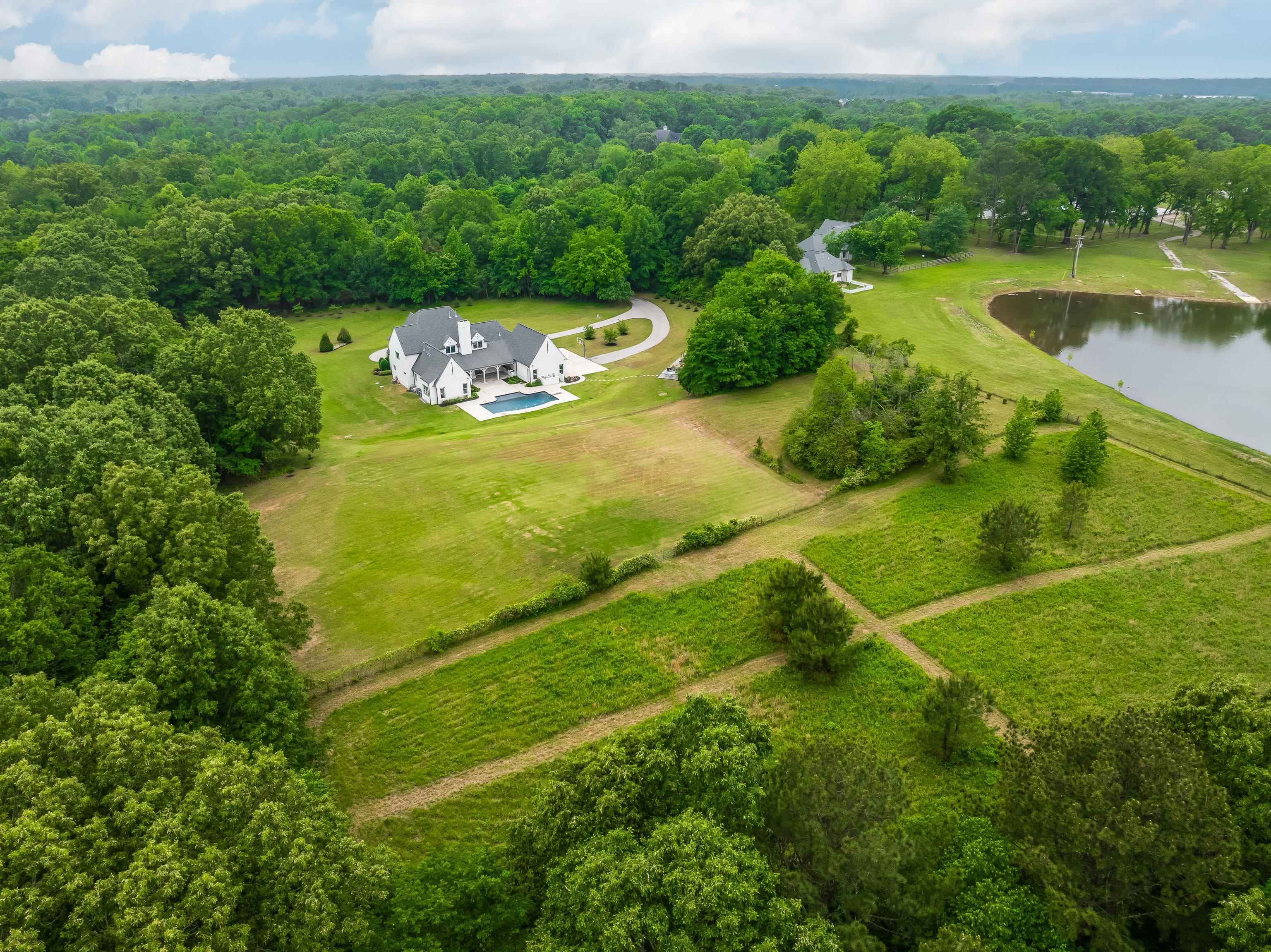 55 East Old State Line Road Piperton, TN 38017 - Photo 40 of 40 Expansive property featuring a white residence with a dark roof, a swimming pool, and a circular driveway