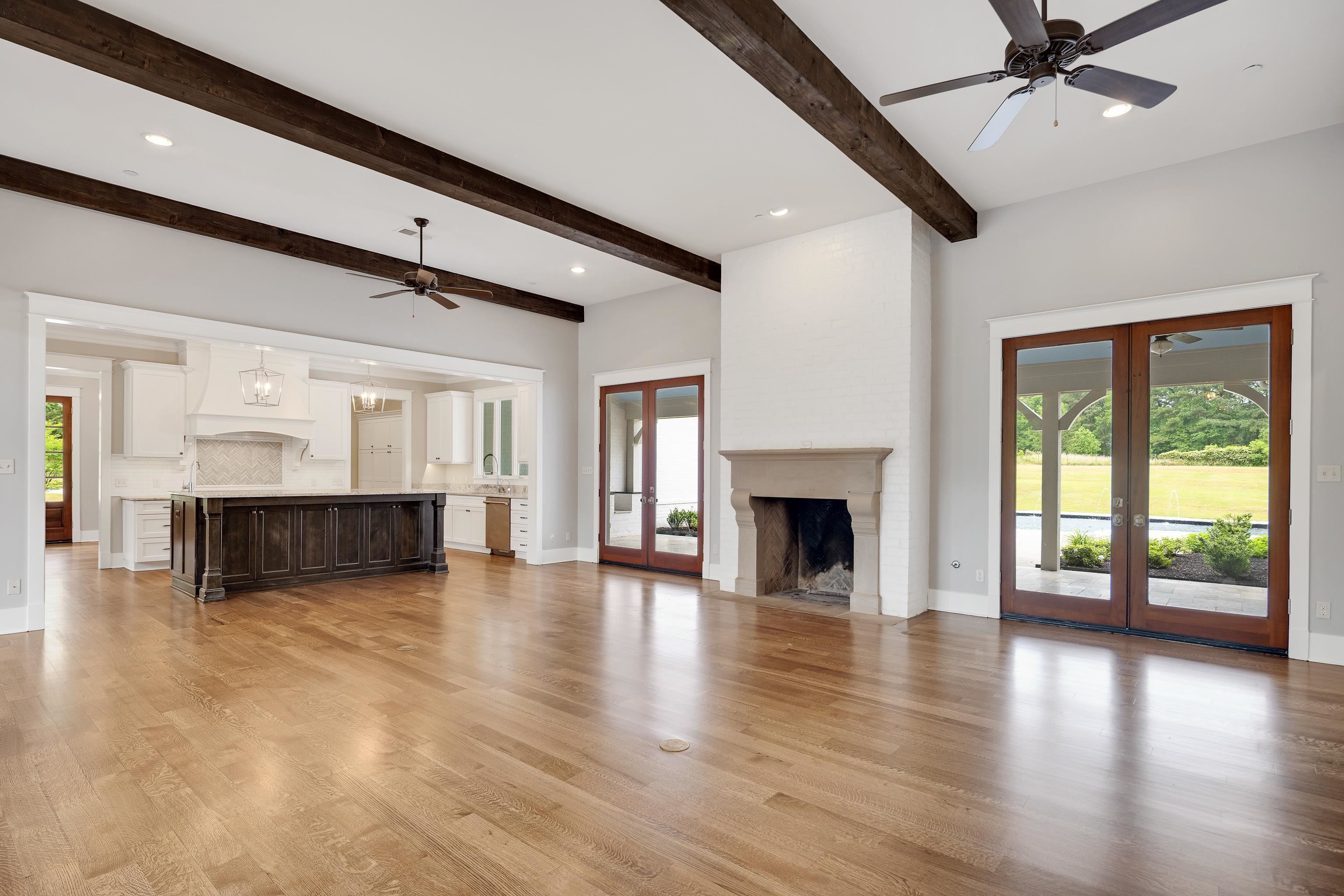 55 East Old State Line Road Piperton, TN 38017 - Photo 7 of 40 Spacious open-concept interior featuring light wood-finish flooring and exposed ceiling beams