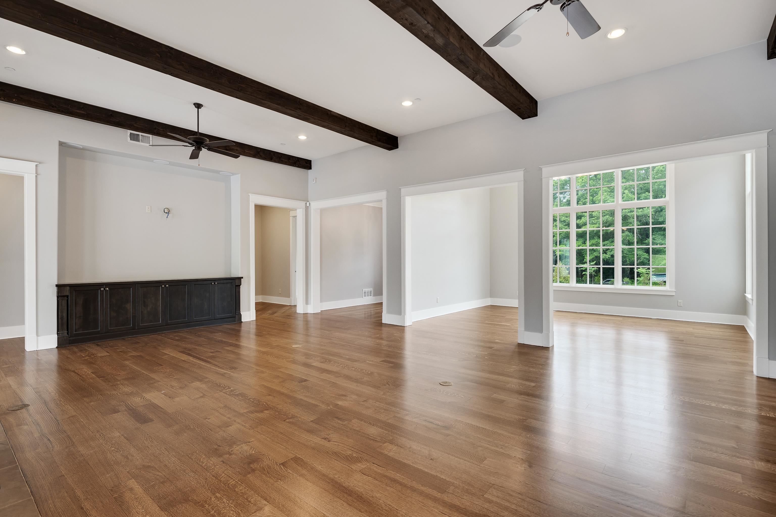 55 East Old State Line Road Piperton, TN 38017 - Photo 10 of 40 Spacious interior featuring wood-finish flooring, exposed ceiling beams, recessed lighting, and a large multi-pane window
