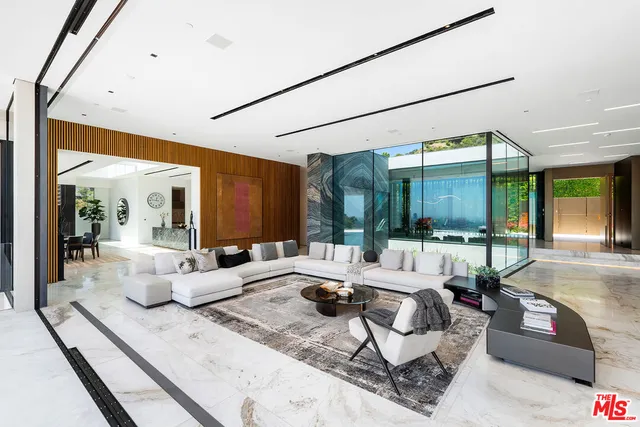 a dining room with furniture and a floor to ceiling window