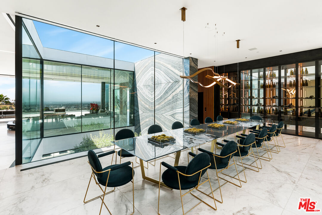 1108 Wallace Ridge Beverly Hills, CA 90210 - Photo 26 of 74 a dining room with furniture and a floor to ceiling window