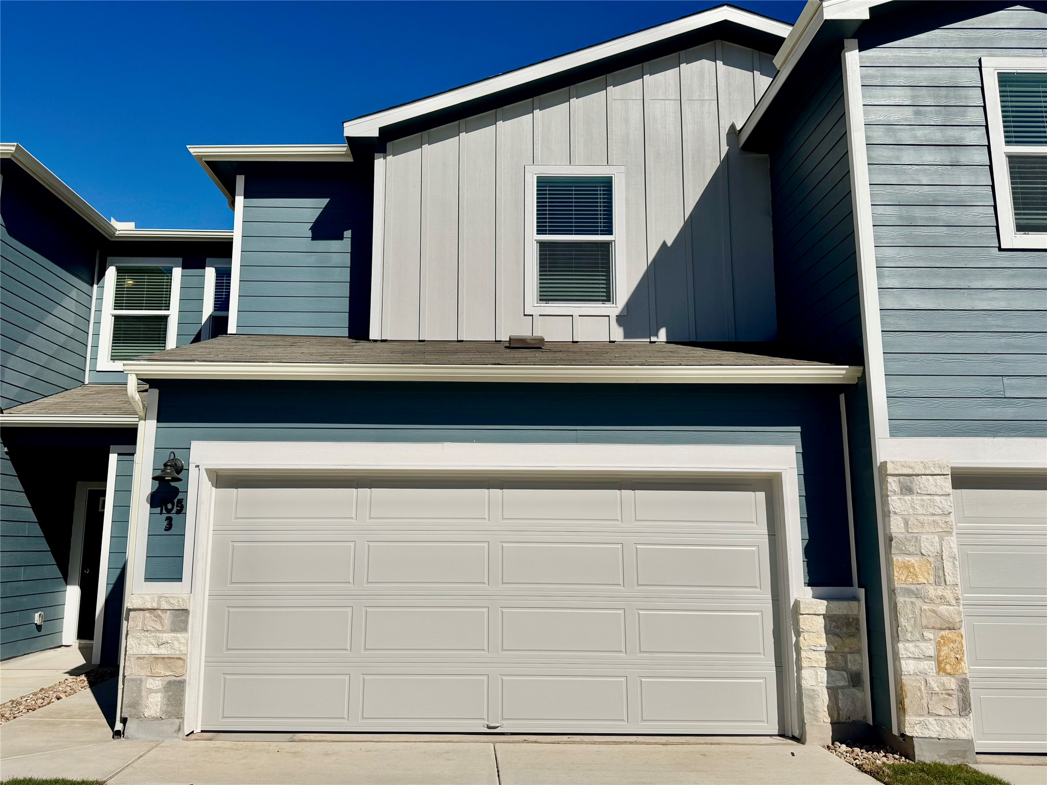 Garage featuring concrete driveway