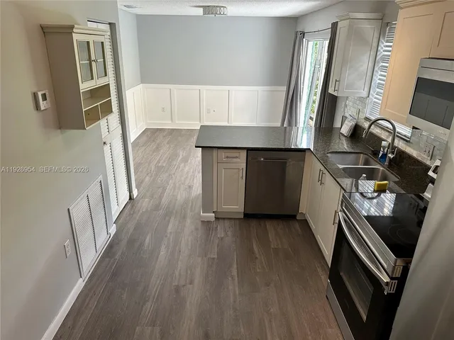 a kitchen with a sink and a window