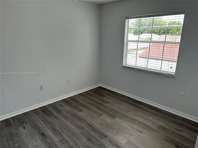 a view of stairs and hall with wooden floor