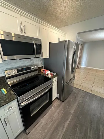 a kitchen with appliances and cabinets