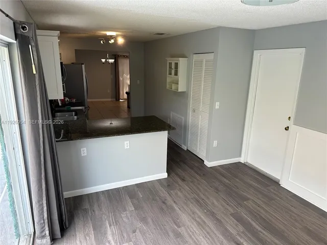 a view of a hallway view with wooden floor and staircase