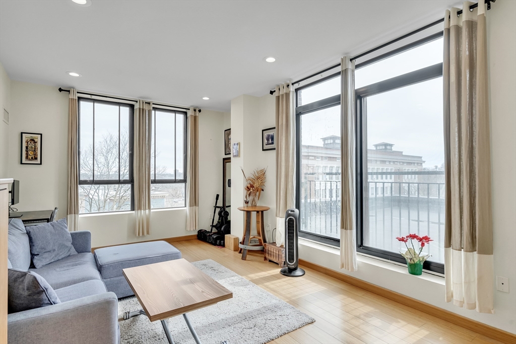 a living room with furniture and a floor to ceiling window
