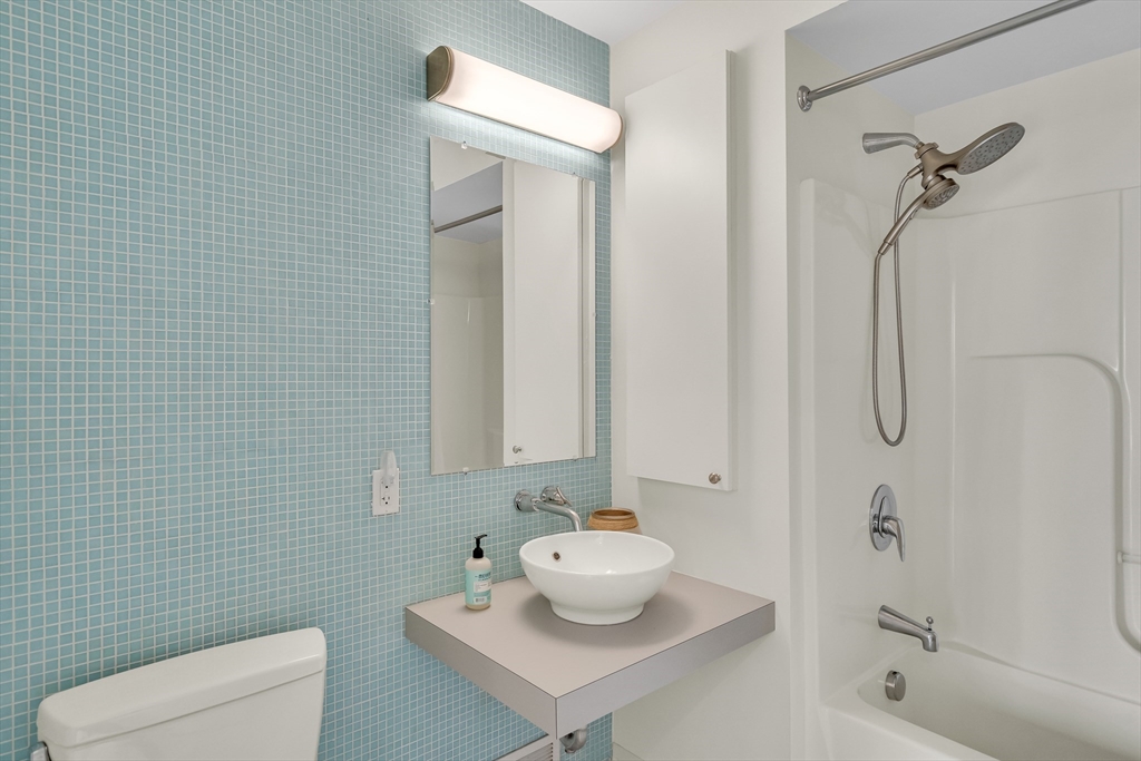 251 Heath Street, Unit 421 Boston, MA 02130 - Photo 11 of 20 a bathroom with a toilet sink and shower