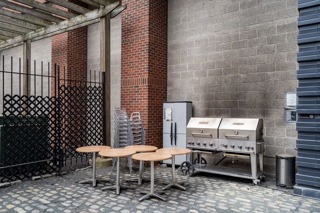 251 Heath Street, Unit 421 Boston, MA 02130 - Photo 18 of 20 a patio with table and chairs