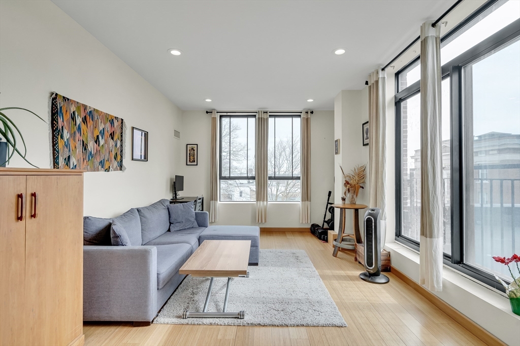 251 Heath Street, Unit 421 Boston, MA 02130 - Photo 2 of 20 a living room with furniture and a large window