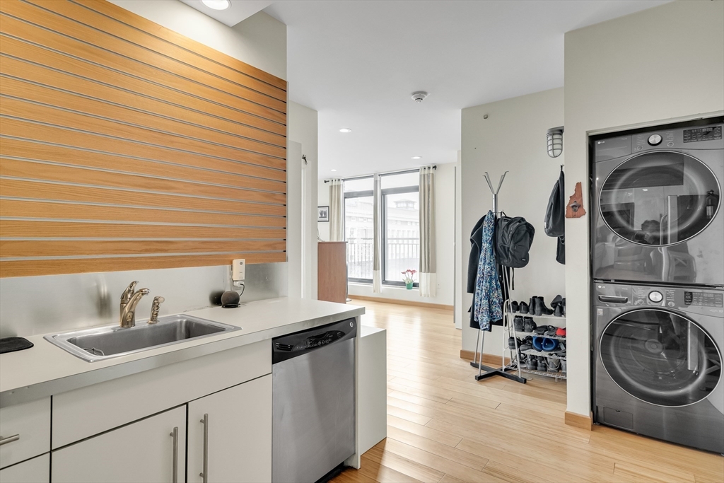 251 Heath Street, Unit 421 Boston, MA 02130 - Photo 6 of 20 a view of a kitchen with sink washer and dryer