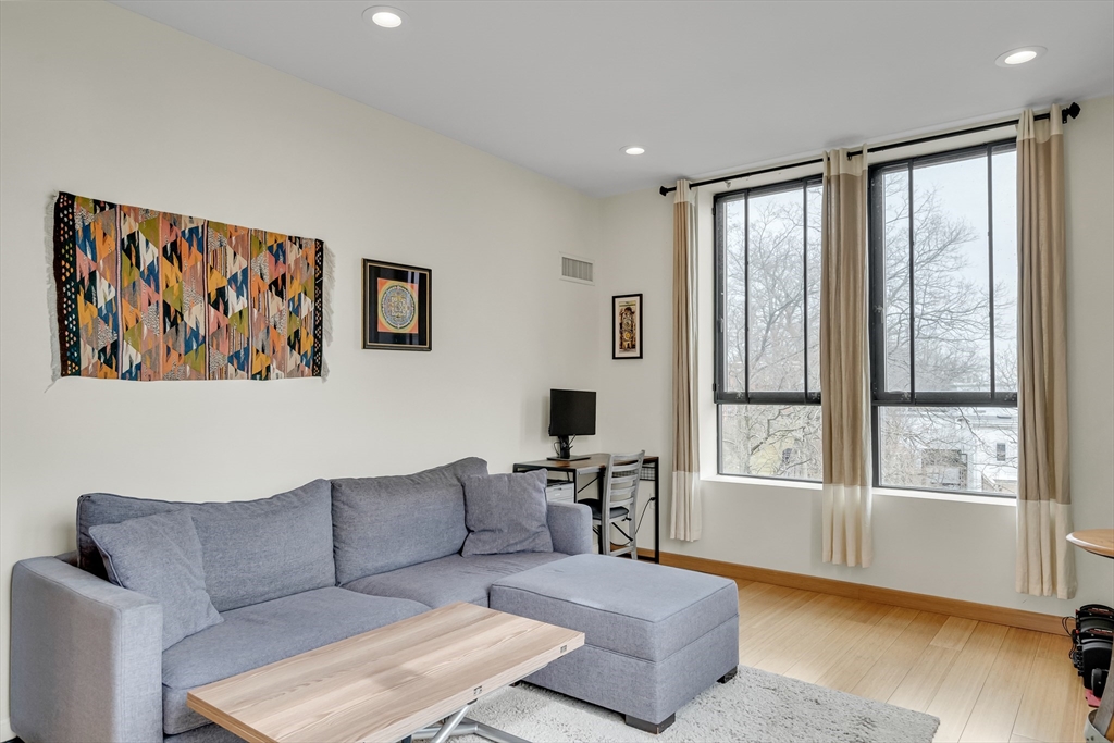 251 Heath Street, Unit 421 Boston, MA 02130 - Photo 9 of 20 a living room with furniture and a large window