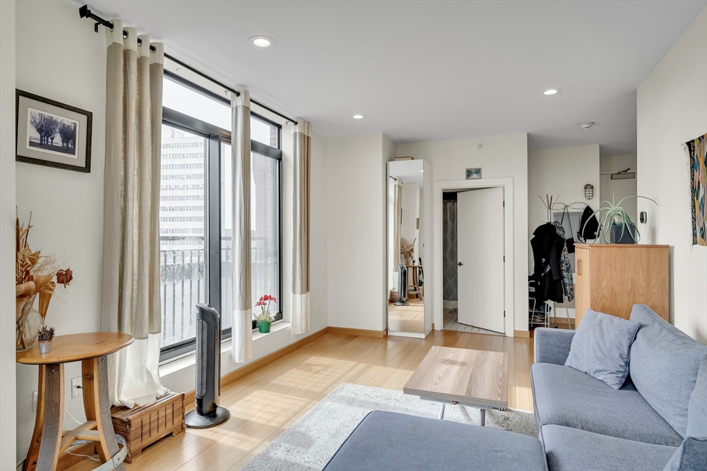 251 Heath Street, Unit 421 Boston, MA 02130 - Photo 10 of 20 a living room with furniture and large windows