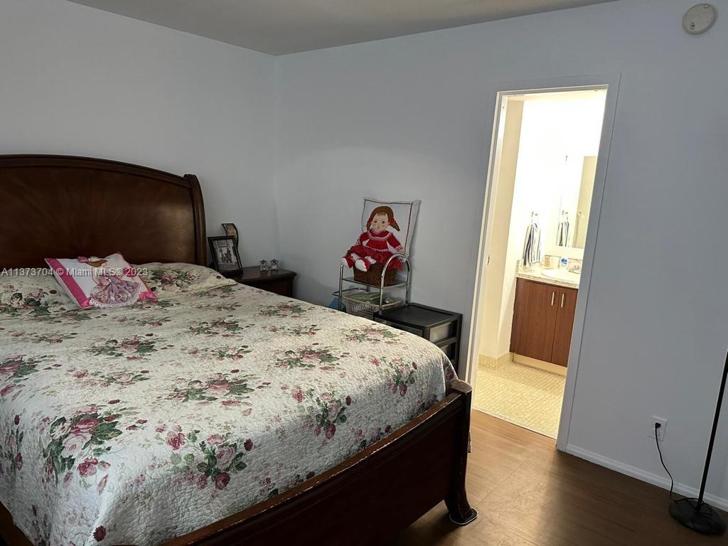 8340 Sands Point Boulevard, Unit P309 Tamarac, FL 33321 - Photo 11 of 33 a bedroom with a bed and a dresser
