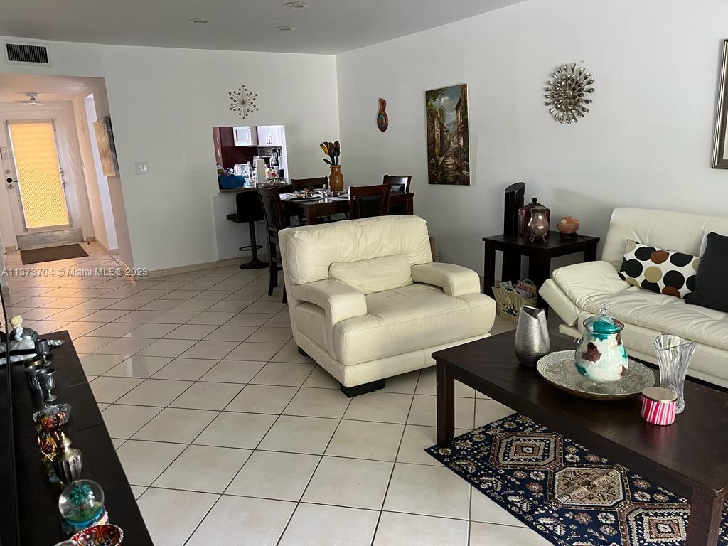 8340 Sands Point Boulevard, Unit P309 Tamarac, FL 33321 - Photo 14 of 33 a living room with furniture and a rug