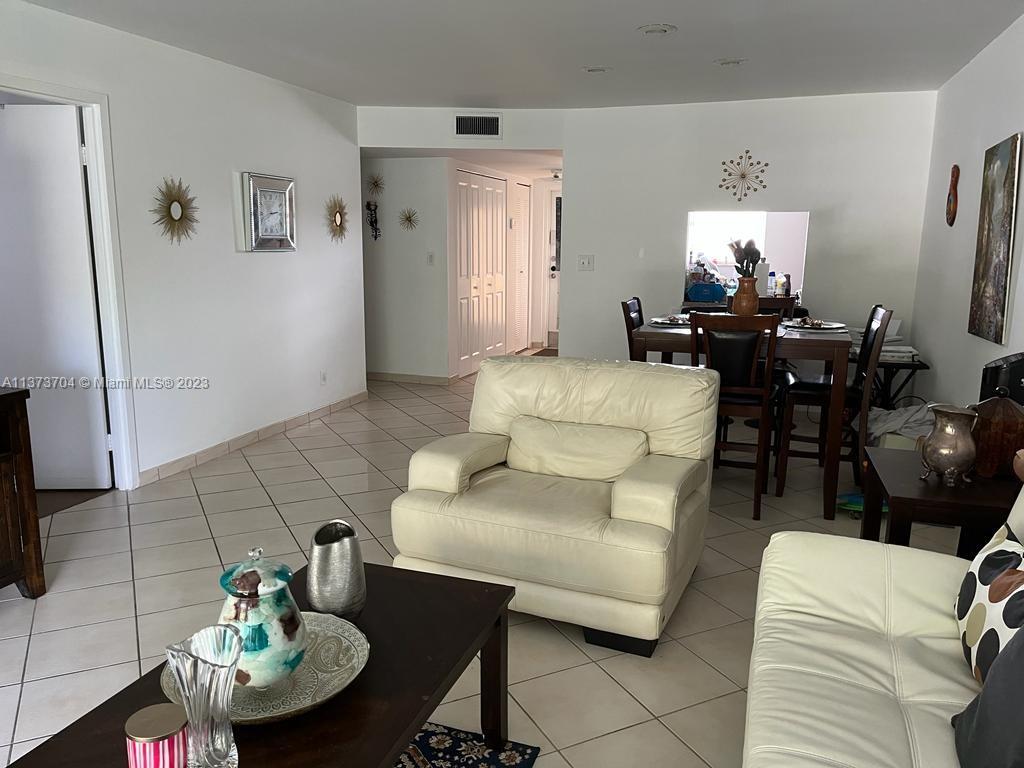 8340 Sands Point Boulevard, Unit P309 Tamarac, FL 33321 - Photo 16 of 33 a living room with furniture and a dining table