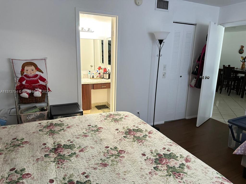 8340 Sands Point Boulevard, Unit P309 Tamarac, FL 33321 - Photo 17 of 33 a bedroom with a bed and a flat screen tv