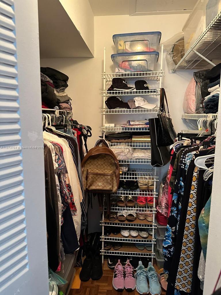 8340 Sands Point Boulevard, Unit P309 Tamarac, FL 33321 - Photo 18 of 33 a view of walk in closet with clothes and shoes