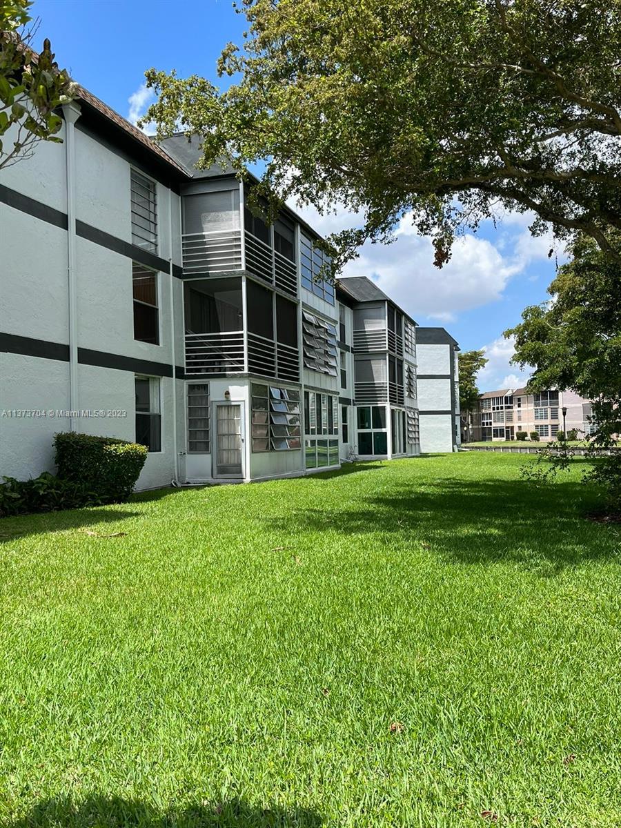 8340 Sands Point Boulevard, Unit P309 Tamarac, FL 33321 - Photo 19 of 33 a view of house with yard