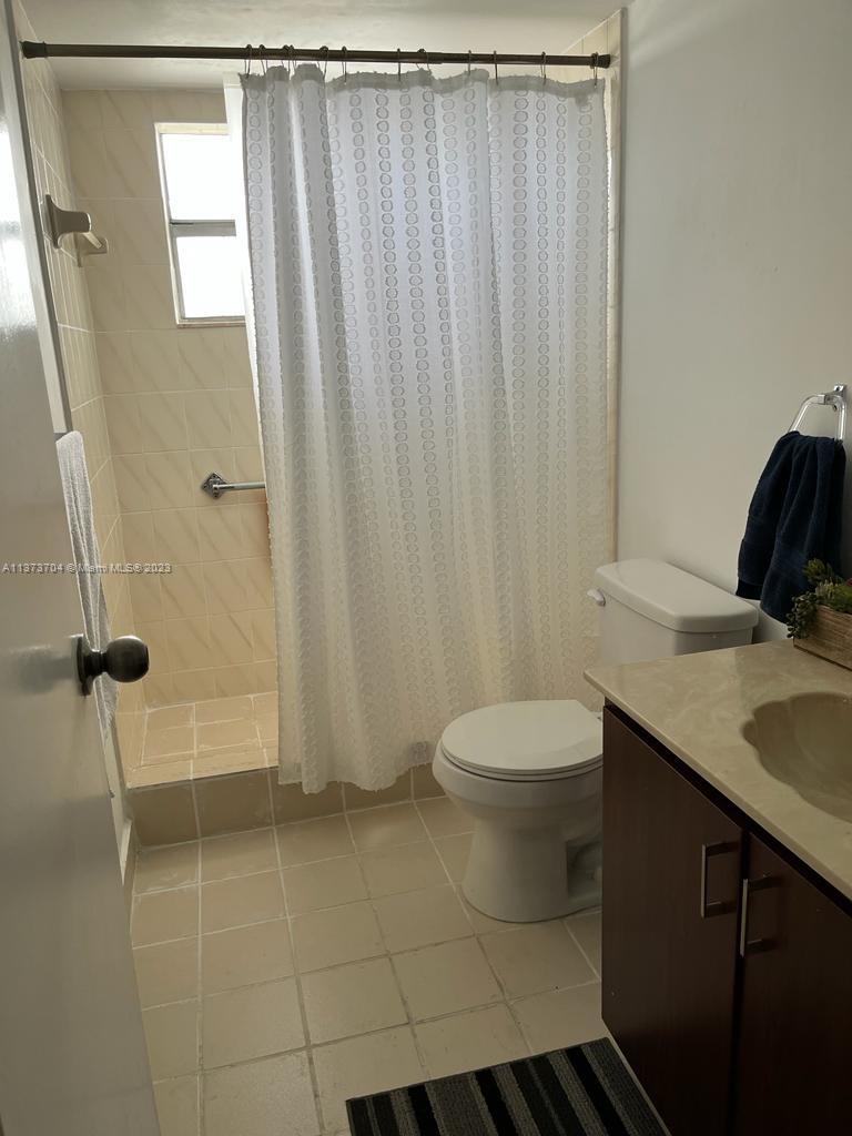 8340 Sands Point Boulevard, Unit P309 Tamarac, FL 33321 - Photo 2 of 33 a bathroom with a granite countertop sink toilet and shower
