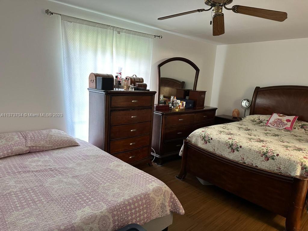 8340 Sands Point Boulevard, Unit P309 Tamarac, FL 33321 - Photo 24 of 33 a bedroom with a bed and a dresser