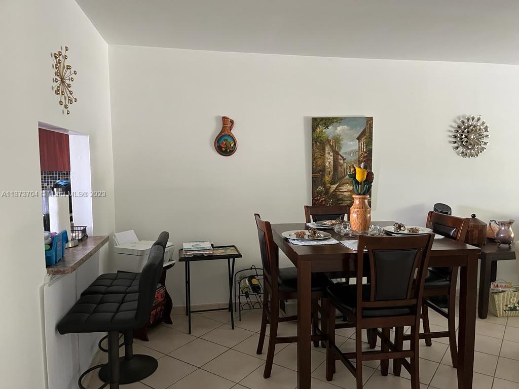 8340 Sands Point Boulevard, Unit P309 Tamarac, FL 33321 - Photo 25 of 33 a view of a dining room with furniture and wooden floor