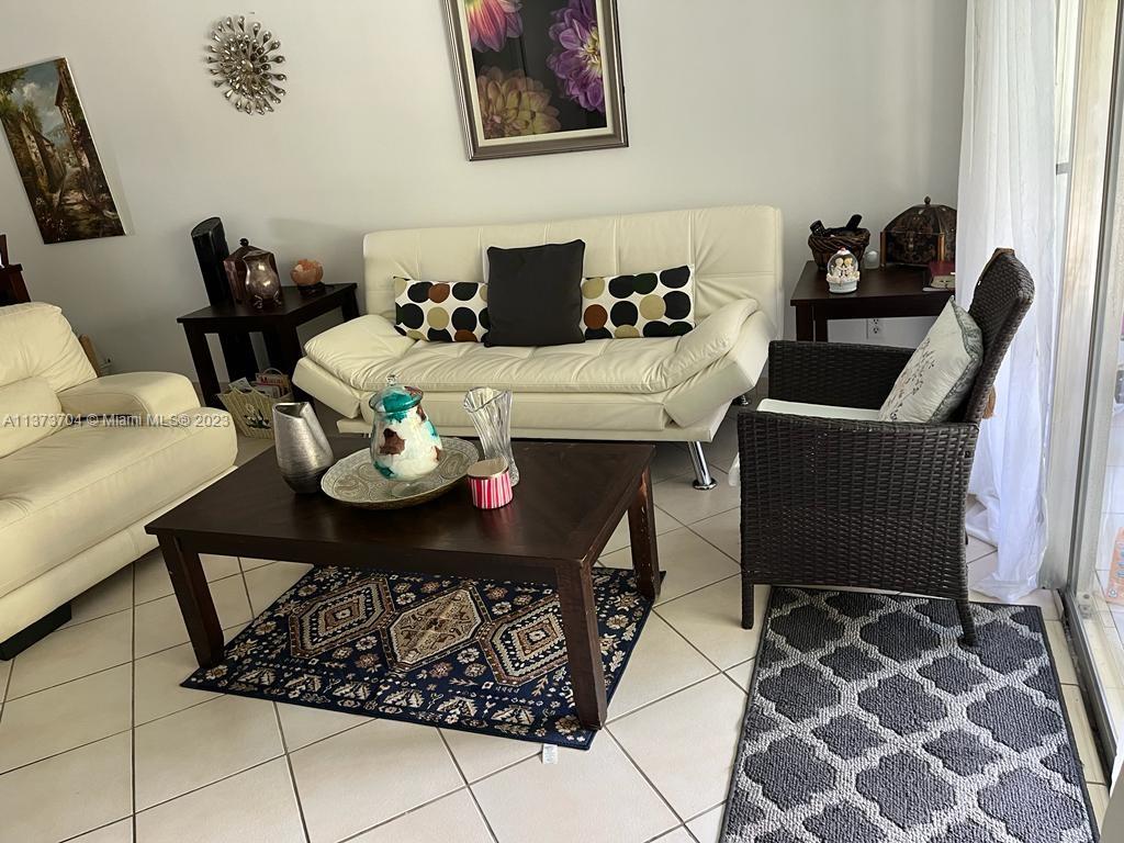 8340 Sands Point Boulevard, Unit P309 Tamarac, FL 33321 - Photo 29 of 33 a dining room with furniture and wooden floor