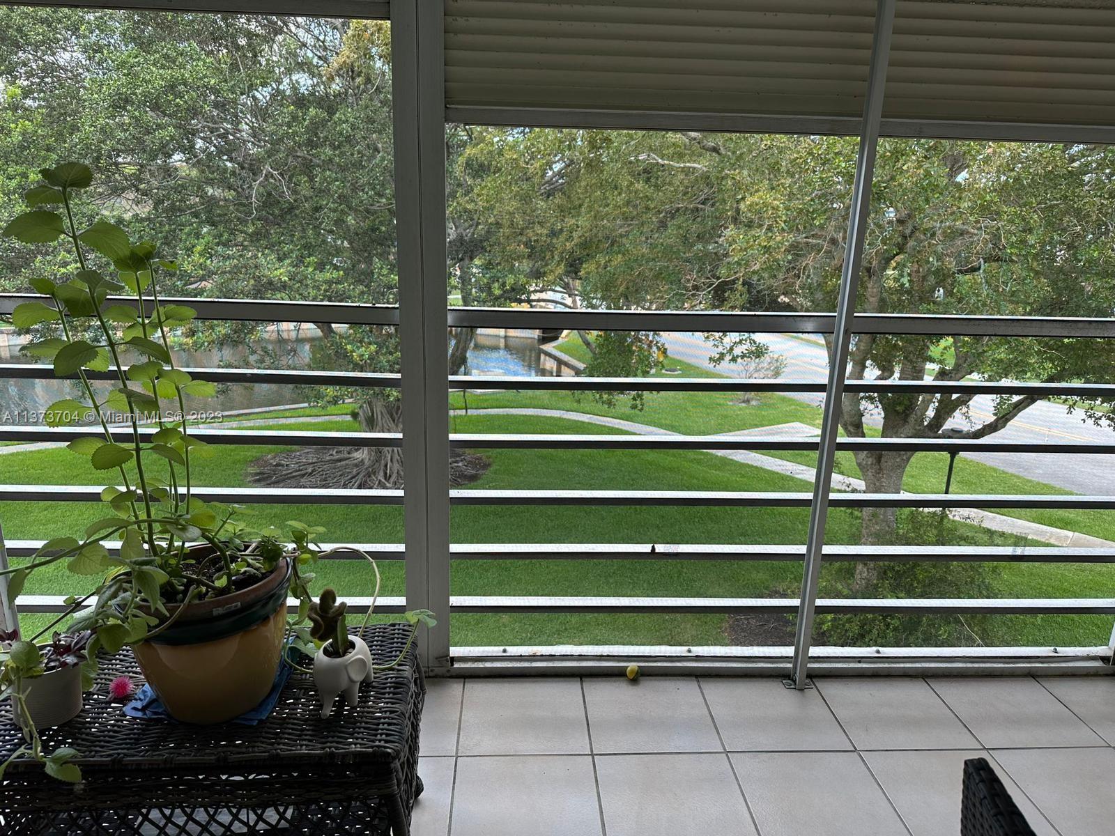 8340 Sands Point Boulevard, Unit P309 Tamarac, FL 33321 - Photo 32 of 33 a view of a chairs and table in a patio